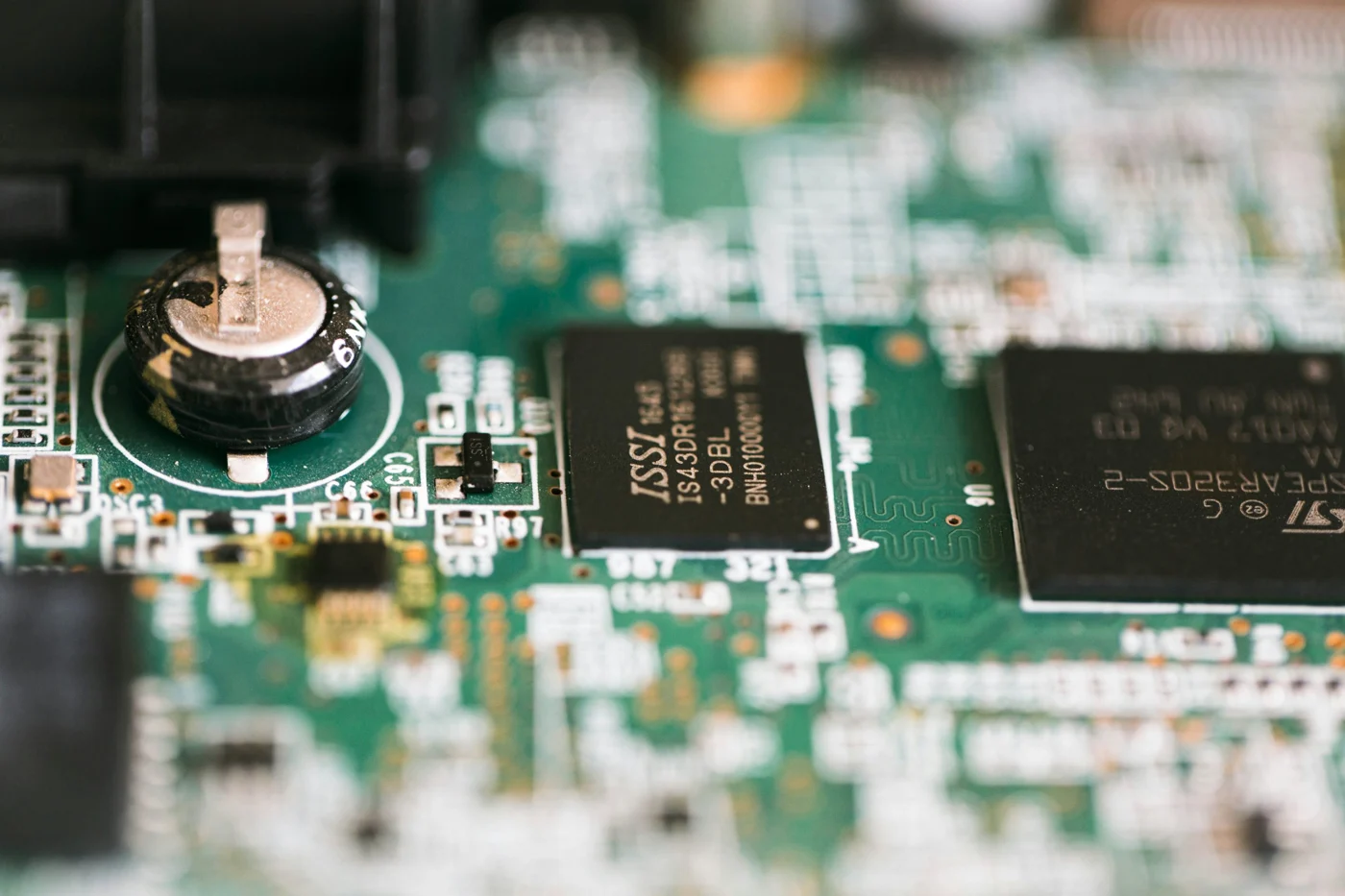 Black integrated circuits and surface-mounted components on a green printed circuit board